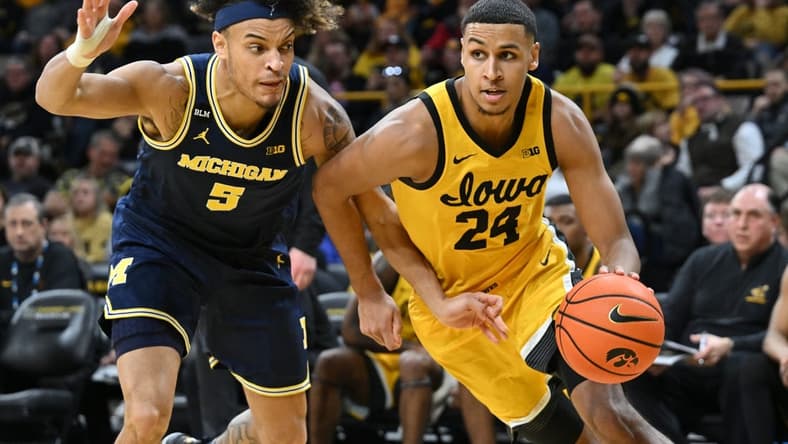 Jan 12, 2023; Iowa City, Iowa, USA; Iowa Hawkeyes forward Kris Murray (24) and Michigan Wolverines forward Terrance Williams II (5) in action during the game at Carver-Hawkeye Arena. Mandatory Credit: Jeffrey Becker-USA TODAY Sports