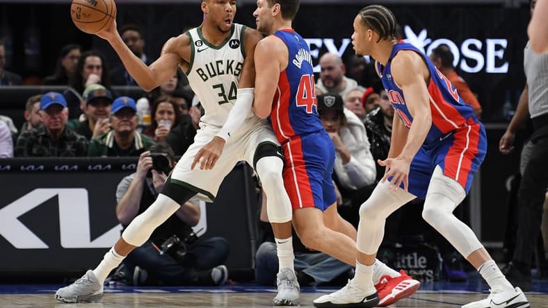 Jan 23, 2023; Detroit, Michigan, USA; Milwaukee Bucks forward Giannis Antetokounmpo (34) looks to pass the ball while being pressured by Detroit Pistons forward Bojan Bogdanovic (44) in the first quarter at Little Caesars Arena. Mandatory Credit: Lon Horwedel-USA TODAY Sports