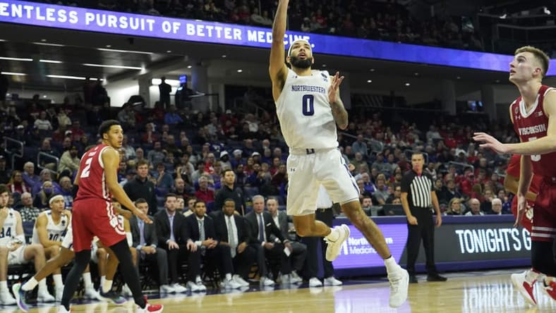 Jan 23, 2023; Evanston, Illinois, USA; Northwestern Wildcats guard Boo Buie (0) scores aWisconsin Badgers during the second half at Welsh-Ryan Arena. Mandatory Credit: David Banks-USA TODAY Sports