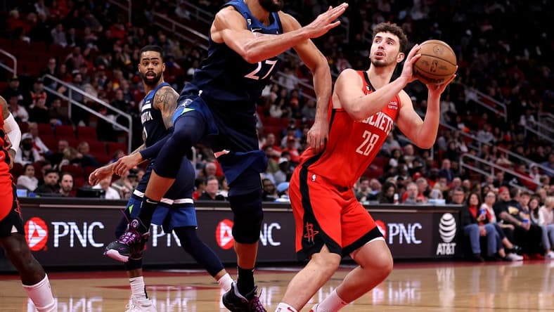 Jan 23, 2023; Houston, Texas, USA; Houston Rockets center Alperen Sengun (28) takes an inside shot while Minnesota Timberwolves center Rudy Gobert (27) defends during the second quarter at Toyota Center. Mandatory Credit: Erik Williams-USA TODAY Sports