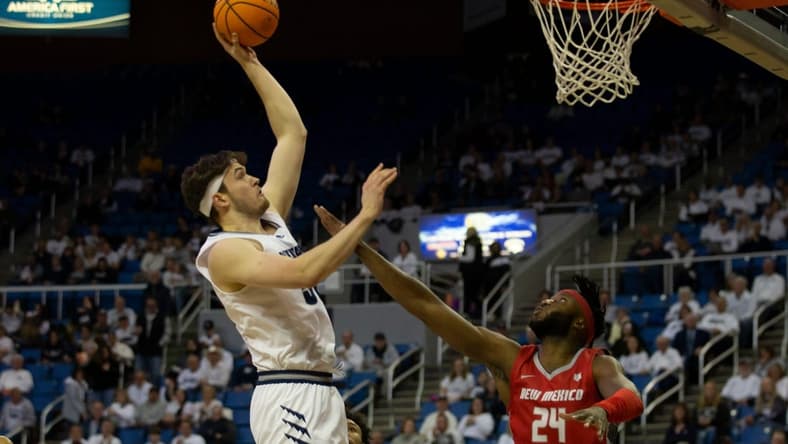 Nevada center Will Baker shoots over New Mexico forward Morris Udeze in the first half of an NCAA college basketball game in Reno, Nev., Monday, Jan. 23, 2023. Tom R Smedes/Special to RGJ
New Mexico At Nevada Basketball 02