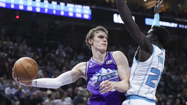 Jan 23, 2023; Salt Lake City, Utah, USA; Utah Jazz forward Lauri Markkanen (23) passes the ball around Charlotte Hornets forward JT Thor (21) in the second quarter at Vivint Arena. Mandatory Credit: Rob Gray-USA TODAY Sports