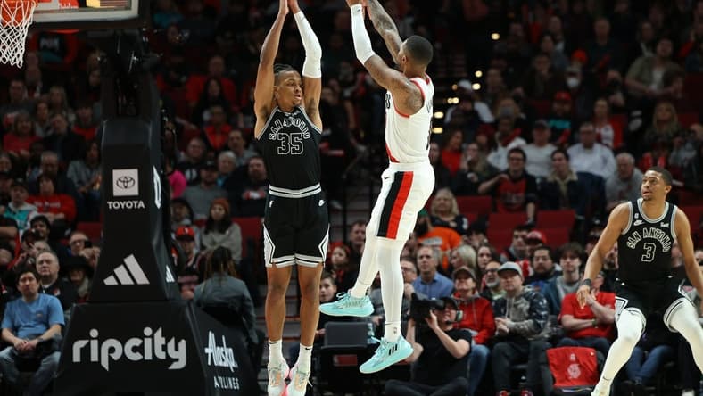 Jan 23, 2023; Portland, Oregon, USA; Portland Trail Blazers guard Damian Lillard (0) shoots the ball over San Antonio Spurs guard Romeo Langford (35) in the second half at Moda Center. Mandatory Credit: Jaime Valdez-USA TODAY Sports