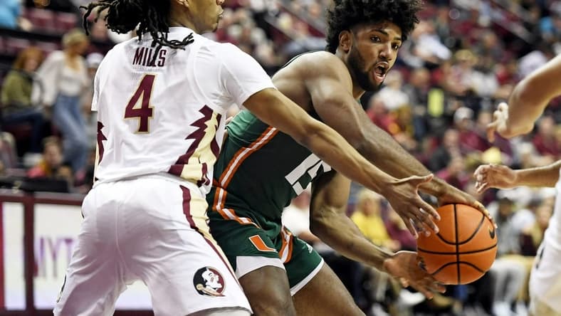 Jan 24, 2023; Tallahassee, Florida, USA; Miami Hurricanes forward Norchad Omier (15) passes the ball around Florida State Seminoles guard Caleb Mills (4) during the first half at Donald L. Tucker Center. Mandatory Credit: Melina Myers-USA TODAY Sports