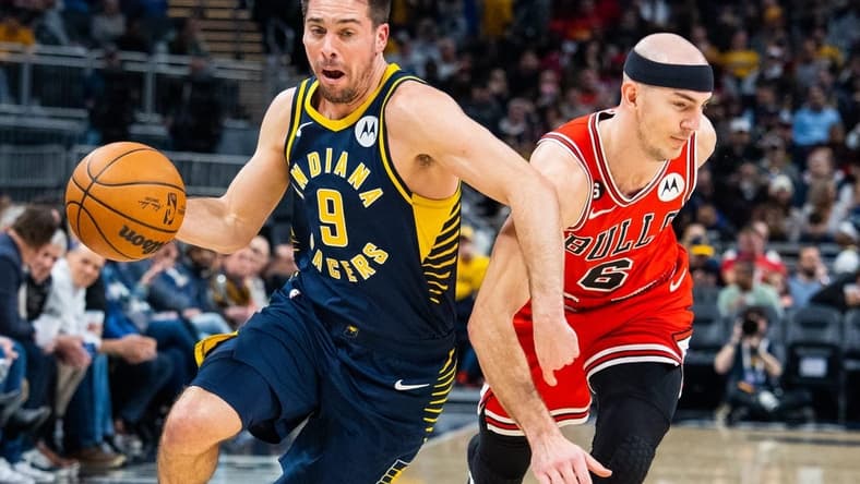 Jan 24, 2023; Indianapolis, Indiana, USA; Indiana Pacers guard T.J. McConnell (9) dribbles the ball while Chicago Bulls guard Alex Caruso (6) defends in the second quarter at Gainbridge Fieldhouse. Mandatory Credit: Trevor Ruszkowski-USA TODAY Sports