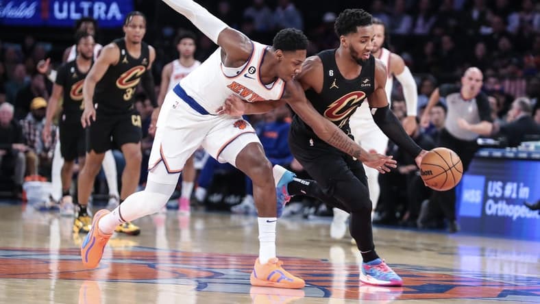 Jan 24, 2023; New York, New York, USA; New York Knicks guard RJ Barrett (9) and Cleveland Cavaliers guard Donovan Mitchell (45) play for the ball in the first quarter at Madison Square Garden. Mandatory Credit: Wendell Cruz-USA TODAY Sports