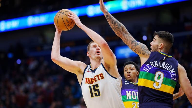 Jan 24, 2023; New Orleans, Louisiana, USA; Denver Nuggets center Nikola Jokic (15) shoots the ball against New Orleans Pelicans center Willy Hernangomez (9) during the first quarter at Smoothie King Center. Mandatory Credit: Andrew Wevers-USA TODAY Sports