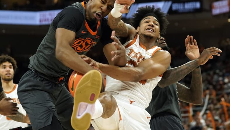 Jan 24, 2023; Austin, Texas, USA; Oklahoma State Cowboys guard Bryce Thompson (1) and Texas Longhorns forward Dillon Mitchell (23) battle for a rebound during the first half at Moody Center. Mandatory Credit: Scott Wachter-USA TODAY Sports