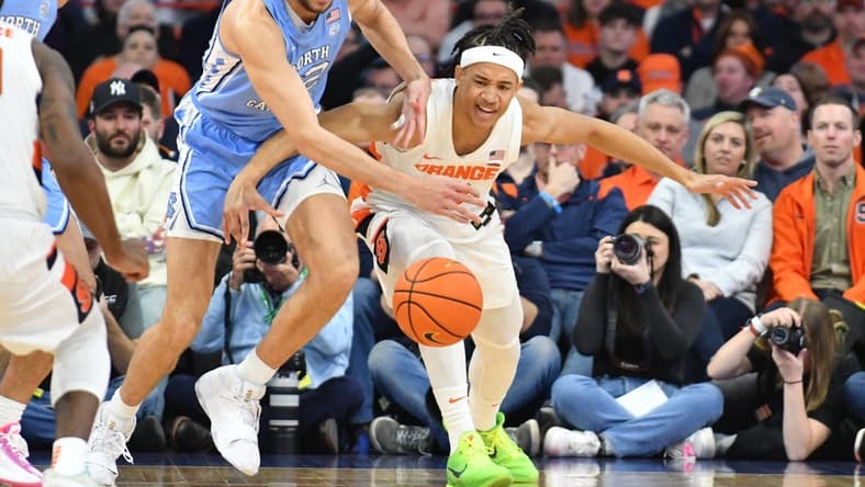 Jan 24, 2023; Syracuse, New York, USA; Syracuse Orange forward Benny Williams (13) and North Carolina Tar Heels forward Pete Nance (32) go for a loose ball in the first half at JMA Wireless Dome. Mandatory Credit: Mark Konezny-USA TODAY Sports