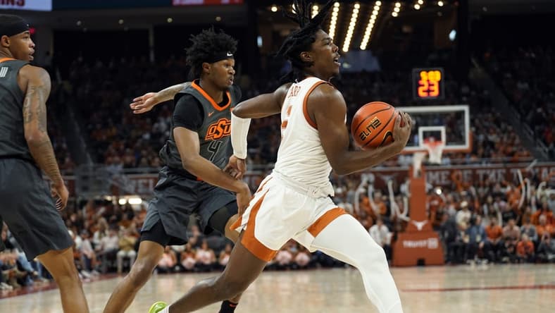 Jan 24, 2023; Austin, Texas, USA; Texas Longhorns guard Marcus Carr (5) drives to the basket past Oklahoma State Cowboys guard Woody Newton (4) during the first half at Moody Center. Mandatory Credit: Scott Wachter-USA TODAY Sports