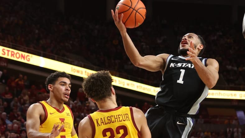 Jan 24, 2023; Ames, Iowa, USA; Kansas State Wildcats guard Markquis Nowell (1) shoots over Iowa State Cyclones guard Tamin Lipsey (3) and Iowa State Cyclones guard Gabe Kalscheur (22) during the first half at James H. Hilton Coliseum. Mandatory Credit: Reese Strickland-USA TODAY Sports