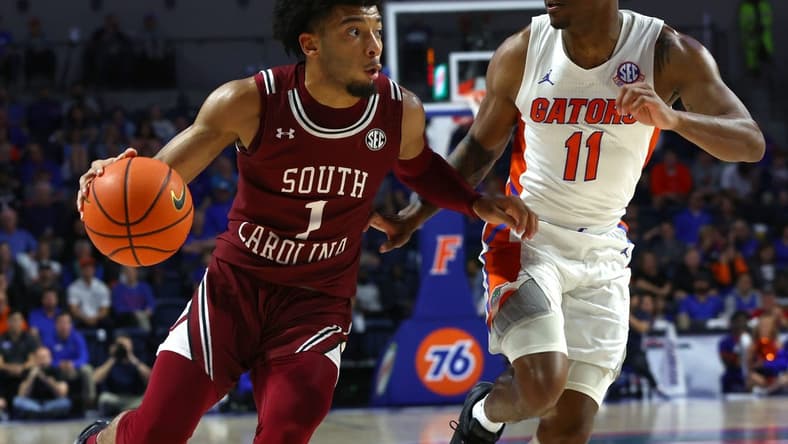 Jan 25, 2023; Gainesville, Florida, USA; South Carolina Gamecocks guard Jacobi Wright (1) drives to the basket as Florida Gators guard Kyle Lofton (11) defends during the first half at Exactech Arena at the Stephen C. O'Connell Center. Mandatory Credit: Kim Klement-USA TODAY Sports