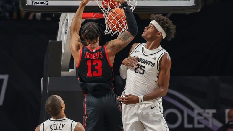Jan 25, 2023; Orlando, Florida, USA; Houston Cougars forward J'Wan Roberts (13) dunks the ball dunks the ball in front of UCF Knights forward Taylor Hendricks (25) during the first half at Addition Financial Arena. Mandatory Credit: Mike Watters-USA TODAY Sports