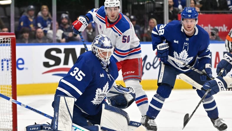 Jan 25, 2023; Toronto, Ontario, CAN; Toronto Maple Leafs goalie Ilya Samsonov (35) makes a save as defenseman Rasmus Sandin (38) and New York Rangers forward Will Cuyle (50) look for the rebound in the second period at Scotiabank Arena. Mandatory Credit: Dan Hamilton-USA TODAY Sports
