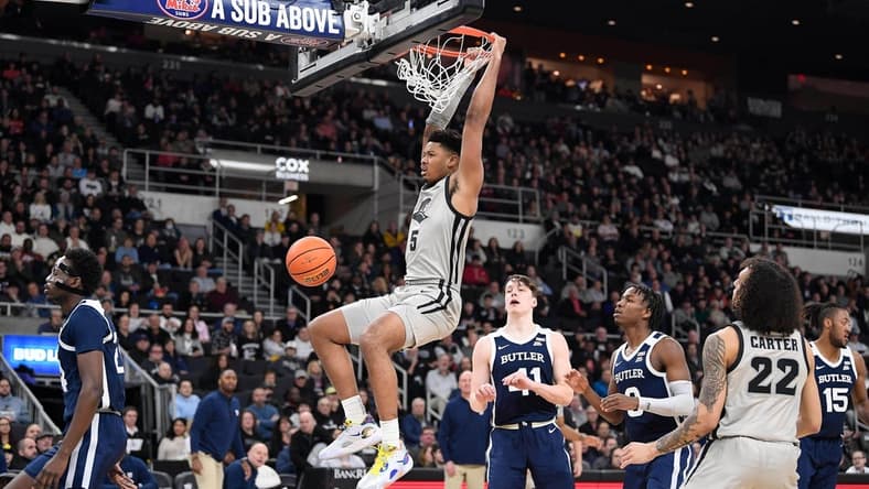 Jan 25, 2023; Providence, Rhode Island, USA; Providence Friars forward Ed Croswell (5) hangs off the basket after dunking against the Butler Bulldogs at Amica Mutual Pavilion. Mandatory Credit: Eric Canha-USA TODAY Sports