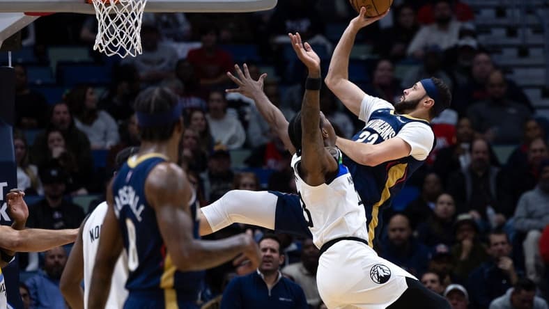 Jan 25, 2023; New Orleans, Louisiana, USA; New Orleans Pelicans forward Larry Nance Jr. (22) shoots a jump shot against Minnesota Timberwolves forward Jaden McDaniels (3) during the first half at Smoothie King Center. Mandatory Credit: Stephen Lew-USA TODAY Sports