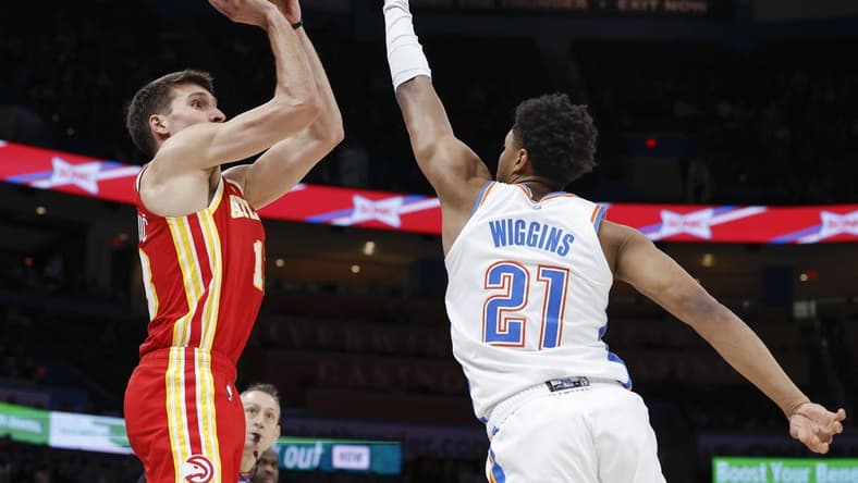 Jan 25, 2023; Oklahoma City, Oklahoma, USA; Atlanta Hawks guard Bogdan Bogdanovic (13) shoots as Oklahoma City Thunder guard Aaron Wiggins (21) defends during the first half at Paycom Center. Mandatory Credit: Alonzo Adams-USA TODAY Sports