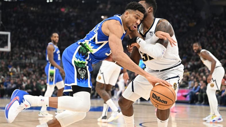 Jan 25, 2023; Milwaukee, Wisconsin, USA; Milwaukee Bucks forward Giannis Antetokounmpo (34) drives to the basket against Denver Nuggets forward Jeff Green (32) in the first half at Fiserv Forum. Mandatory Credit: Michael McLoone-USA TODAY Sports