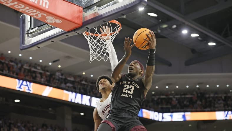 Jan 25, 2023; Auburn, Alabama, USA; Texas A&M Aggies guard Tyrece Radford (23) gets past Auburn Tigers center Dylan Cardwell (44) for a shot during the first half at Neville Arena. Mandatory Credit: John Reed-USA TODAY Sports