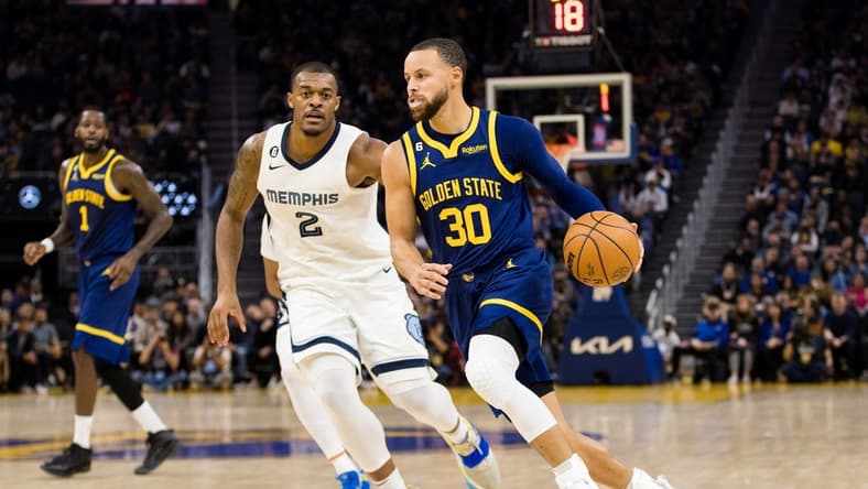 Jan 25, 2023; San Francisco, California, USA; Golden State Warriors guard Stephen Curry (30) dribbles past Memphis Grizzlies center Xavier Tillman Sr. (2) during the first half at Chase Center. Mandatory Credit: John Hefti-USA TODAY Sports