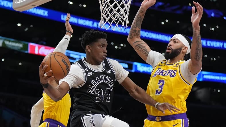 Jan 25, 2023; Los Angeles, California, USA; San Antonio Spurs forward Stanley Johnson (34) passes the ball against Los Angeles Lakers forward Anthony Davis (3) and guard Russell Westbrook (0) in the first half at Crypto.com Arena. Mandatory Credit: Kirby Lee-USA TODAY Sports