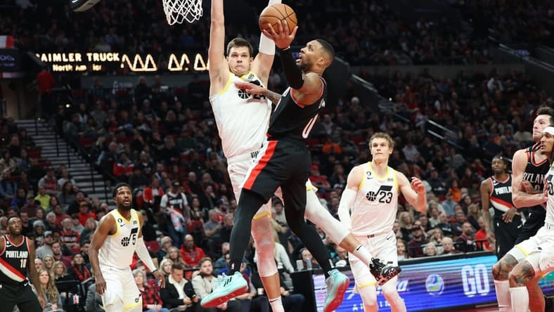 Jan 25, 2023; Portland, Oregon, USA; Portland Trail Blazers guard Damian Lillard (0) shoots over Utah Jazz forward Jarred Vanderbilt (8) in the second half at Moda Center. Mandatory Credit: Jaime Valdez-USA TODAY Sports