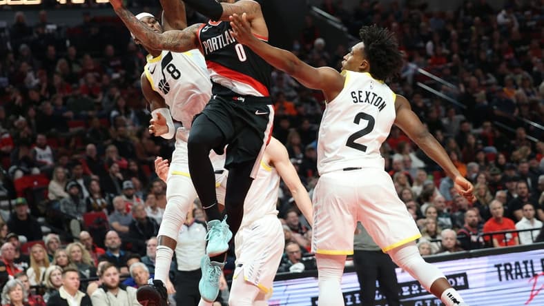 Jan 25, 2023; Portland, Oregon, USA; Portland Trail Blazers guard Damian Lillard (0) shoots over Utah Jazz forward Jarred Vanderbilt (8) and guard Collin Sexton (2) in the second half at Moda Center. Mandatory Credit: Jaime Valdez-USA TODAY Sports