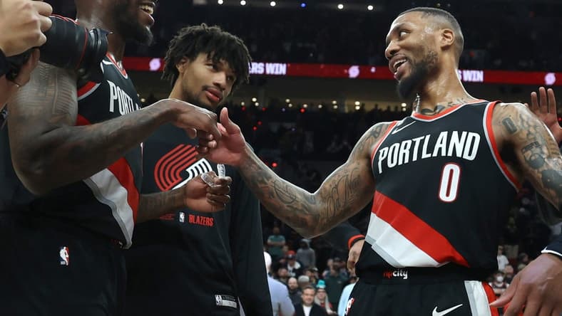 Jan 25, 2023; Portland, Oregon, USA; Portland Trail Blazers guard Damian Lillard (0) is congratulated by teammate forward Nassir Little (10) after scoring 60 points at Moda Center. Mandatory Credit: Jaime Valdez-USA TODAY Sports