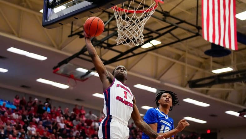 Jan 26, 2023; Boca Raton, Florida, USA; Florida Atlantic Owls guard Johnell Davis (1) shoots over Middle Tennessee Blue Raiders guard Teafale Lenard Jr. (12) during the first half at Eleanor R. Baldwin Arena. Mandatory Credit: Rich Storry-USA TODAY Sports