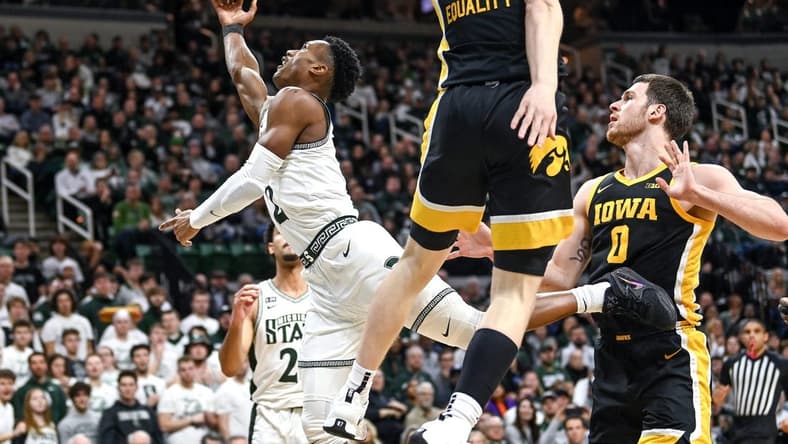 Michigan State's Tyson Walker, left, shoots a layup as Iowa's Filip Rebraca defends during the first half on Thursday, Jan. 26, 2023, at the Breslin Center in Lansing.
230126 Msu Iowa Bball 059a