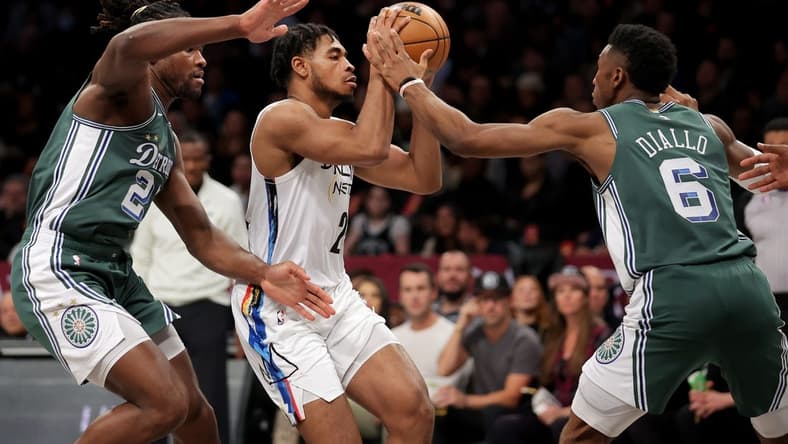 Jan 26, 2023; Brooklyn, New York, USA; Brooklyn Nets guard Cam Thomas (24) looks to pass the ball against Detroit Pistons center Isaiah Stewart (28) and guard Hamidou Diallo (6) during the first quarter at Barclays Center. Mandatory Credit: Brad Penner-USA TODAY Sports