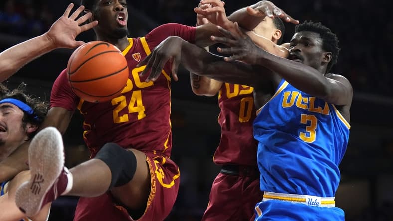 Jan 26, 2023; Los Angeles, California, USA; Southern California Trojans forward Joshua Morgan (24) and forward Kobe Johnson (0) battles for the ball with UCLA Bruins guard Jaime Jaquez Jr. (24) and forward Adem Bona (3) in the firsthalf at Galen Center. Mandatory Credit: Kirby Lee-USA TODAY Sports
