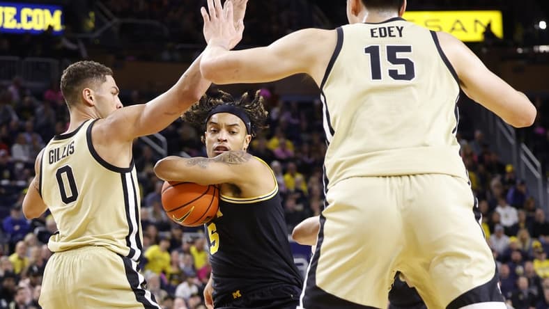 Jan 26, 2023; Ann Arbor, Michigan, USA; Michigan Wolverines forward Terrance Williams II (5) is defended by Purdue Boilermakers forward Mason Gillis (0) and center Zach Edey (15) in the first half at Crisler Center. Mandatory Credit: Rick Osentoski-USA TODAY Sports