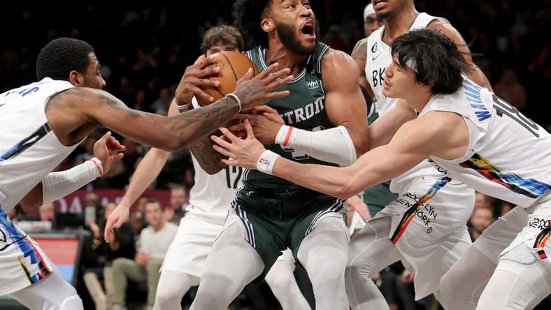 Jan 26, 2023; Brooklyn, New York, USA; Detroit Pistons forward Saddiq Bey (41) drives to the basket against Brooklyn Nets guard Kyrie Irving (11) and forward Joe Harris (12) and center Nic Claxton (33) and forward Yuta Watanabe (18) during the fourth quarter at Barclays Center. Mandatory Credit: Brad Penner-USA TODAY Sports