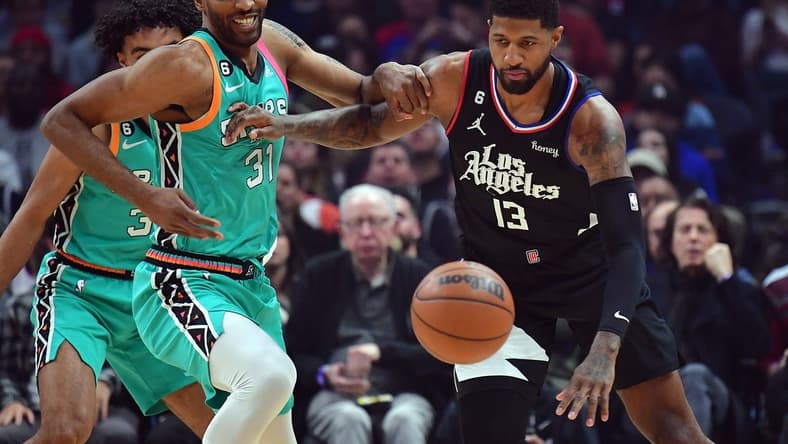 Jan 26, 2023; Los Angeles, California, USA; San Antonio Spurs forward Keita Bates-Diop (31) plays for the ball against Los Angeles Clippers guard Paul George (13) during the first half at Crypto.com Arena. Mandatory Credit: Gary A. Vasquez-USA TODAY Sports
