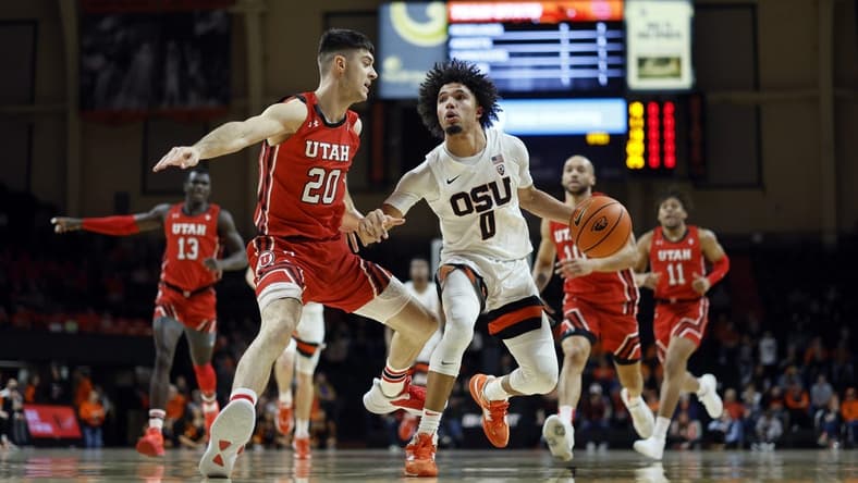 Jan 26, 2023; Corvallis, Oregon, USA; Oregon State Beavers guard Jordan Pope (0) dribbles the ball while defended by Utah Utes guard Lazar Stefanovic (20) during the first half at Gill Coliseum. Mandatory Credit: Soobum Im-USA TODAY Sports