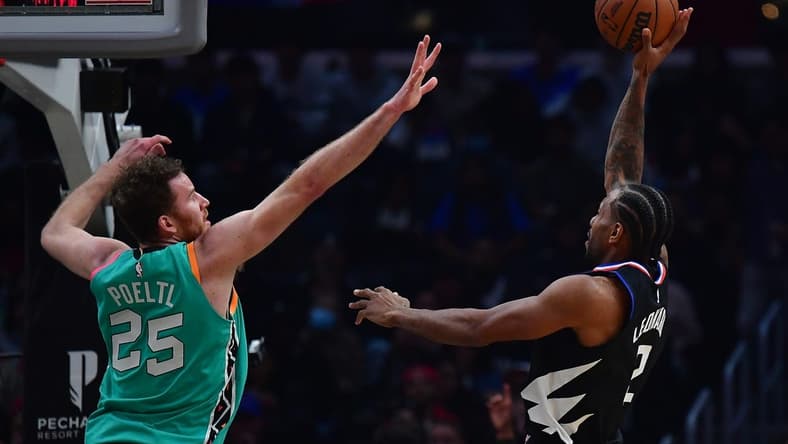 Jan 26, 2023; Los Angeles, California, USA; Los Angeles Clippers forward Kawhi Leonard (2) shoots against San Antonio Spurs center Jakob Poeltl (25) during the first half at Crypto.com Arena. Mandatory Credit: Gary A. Vasquez-USA TODAY Sports