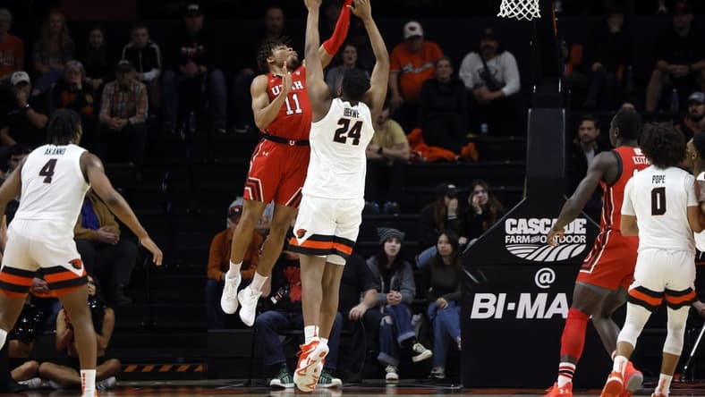 Jan 26, 2023; Corvallis, Oregon, USA; Utah Utes guard Wilguens Jr. Exacte (11) shoots under pressure from Oregon State Beavers center KC Ibekwe (24) during the first half at Gill Coliseum. Mandatory Credit: Soobum Im-USA TODAY Sports