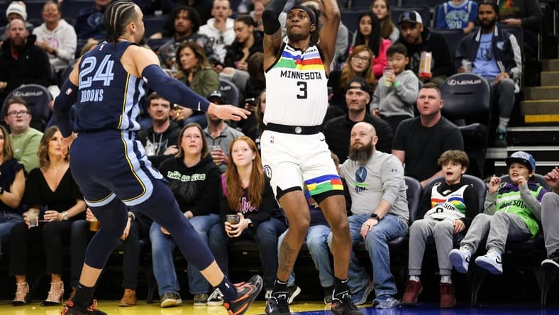 Jan 27, 2023; Minneapolis, Minnesota, USA; Minnesota Timberwolves forward Jaden McDaniels (3) shoots while Memphis Grizzlies forward Dillon Brooks (24) defends during the first quarter at Target Center. Mandatory Credit: Matt Krohn-USA TODAY Sports