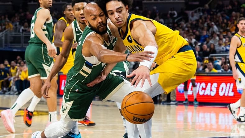 Jan 27, 2023; Indianapolis, Indiana, USA; Milwaukee Bucks guard Jevon Carter (5) steals the ball from Indiana Pacers guard Andrew Nembhard (2) in the second quarter at Gainbridge Fieldhouse. Mandatory Credit: Trevor Ruszkowski-USA TODAY Sports