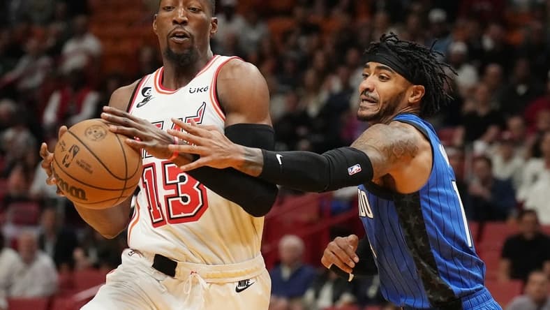 Jan 27, 2023; Miami, Florida, USA; Orlando Magic guard Gary Harris (14) defends Miami Heat center Bam Adebayo (13) during the first half at Miami-Dade Arena. Mandatory Credit: Jim Rassol-USA TODAY Sports