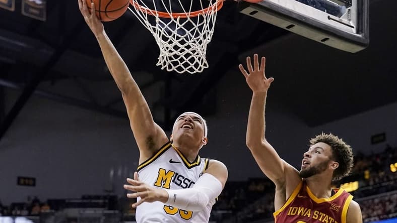 Jan 28, 2023; Columbia, Missouri, USA; Missouri Tigers forward Noah Carter (left) shoots the ball against Iowa State Cyclones guard Gabe Kalscheur (right) during the first half at Mizzou Arena. Mandatory Credit: Denny Medley-USA TODAY Sports