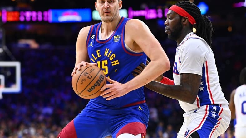 Jan 28, 2023; Philadelphia, Pennsylvania, USA; Denver Nuggets center Nikola Jokic (15) controls the ball against Philadelphia 76ers center Montrezl Harrell (5) in the first quarter at Wells Fargo Center. Mandatory Credit: Kyle Ross-USA TODAY Sports
