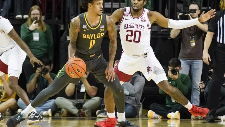Jan 28, 2023; Waco, Texas, USA;  Baylor Bears forward Jalen Bridges (11) controls the ball against Arkansas Razorbacks forward Kamani Johnson (20) during the first half at Ferrell Center. Mandatory Credit: Raymond Carlin III-USA TODAY Sports