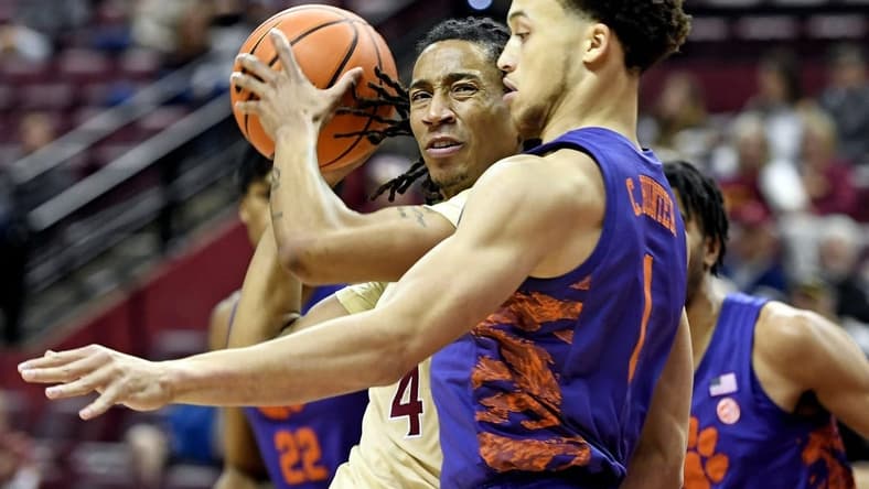 Jan 28, 2023; Tallahassee, Florida, USA; Florida State Seminoles guard Caleb Mills (4) controls the ball against Clemson Tigers guard Chase Hunter (1) during the first half at Donald L. Tucker Center. Mandatory Credit: Melina Myers-USA TODAY Sports