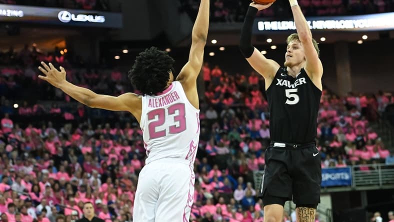 Jan 28, 2023; Omaha, Nebraska, USA; Xavier Musketeers guard Adam Kunkel (5) scores over Creighton Bluejays guard Trey Alexander (23) in the first half at CHI Health Center Omaha. Mandatory Credit: Steven Branscombe-USA TODAY Sports