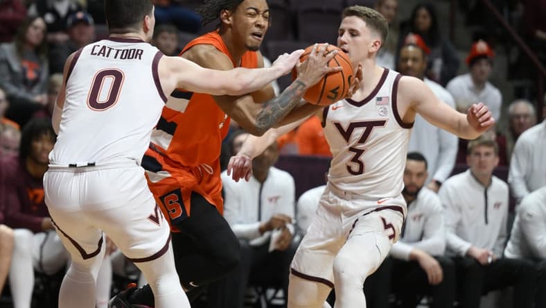 Jan 28, 2023; Blacksburg, Virginia, USA; Syracuse Orange guard Judah Mintz (3) is defended by Virginia Tech Hokies guard Hunter Cattoor (0) and guard Sean Pedulla (3) in the first half at Cassell Coliseum. Mandatory Credit: Lee Luther Jr.-USA TODAY Sports