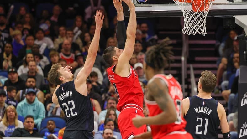 Jan 28, 2023; Orlando, Florida, USA; Chicago Bulls center Nikola Vucevic (9) goes to the basket in front of Orlando Magic forward Franz Wagner (22) during the second quarter at Amway Center. Mandatory Credit: Mike Watters-USA TODAY Sports