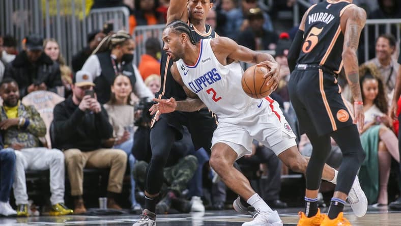 Jan 28, 2023; Atlanta, Georgia, USA; LA Clippers forward Kawhi Leonard (2) is defended by Atlanta Hawks forward De'Andre Hunter (12) in the first quarter at State Farm Arena. Mandatory Credit: Brett Davis-USA TODAY Sports