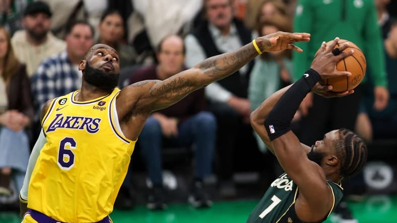 Jan 28, 2023; Boston, Massachusetts, USA; Boston Celtics forward Jaylen Brown (7) shoots defended by Los Angeles Lakers forward LeBron James (6) during the second half at TD Garden. Mandatory Credit: Paul Rutherford-USA TODAY Sports